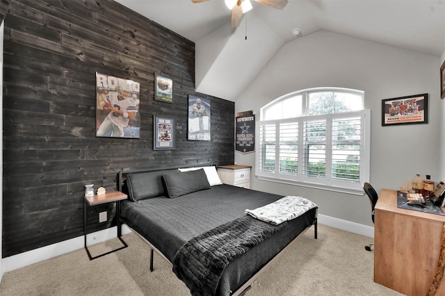 carpeted bedroom featuring ceiling fan, lofted ceiling, and wood walls