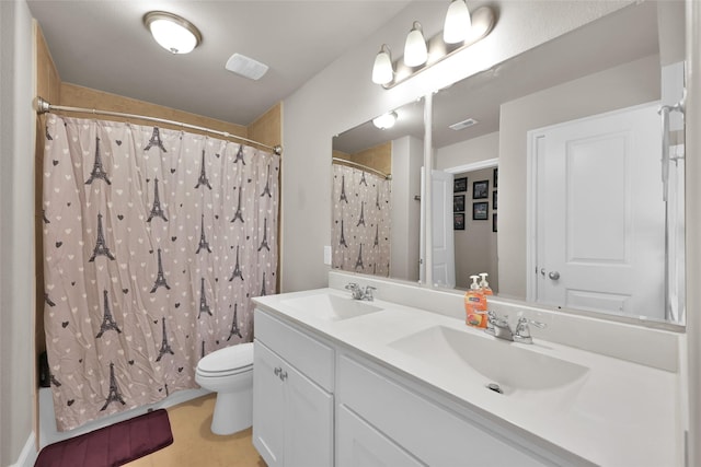 bathroom featuring toilet, vanity, and a shower with shower curtain