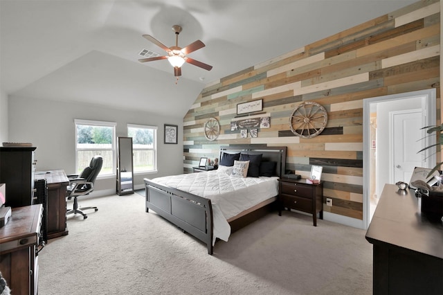 bedroom featuring ceiling fan, light colored carpet, lofted ceiling, and wood walls