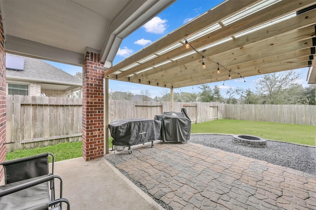 view of patio / terrace with grilling area, a pergola, and a fire pit