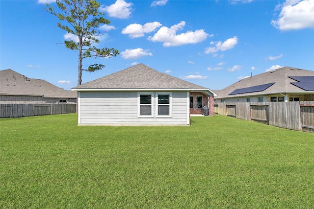 rear view of house featuring a yard