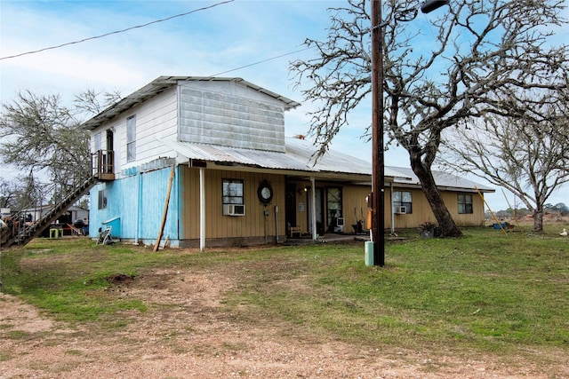 view of front of home with a front yard and cooling unit