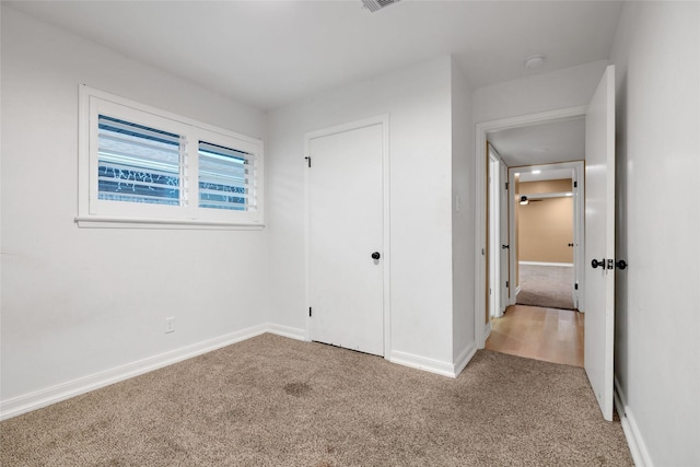 unfurnished bedroom with light colored carpet