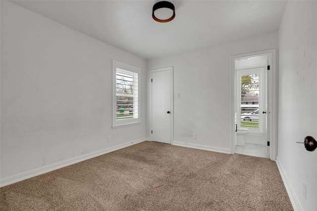 carpeted empty room with plenty of natural light