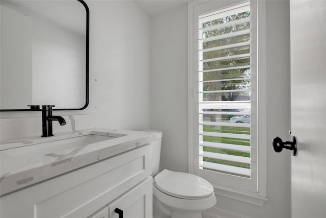 bathroom featuring toilet and vanity