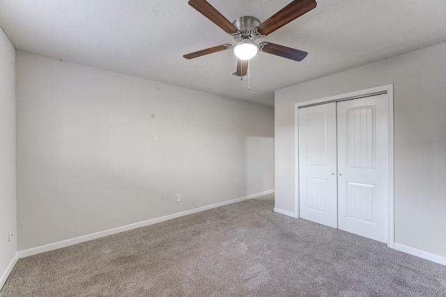 unfurnished bedroom with ceiling fan, a closet, and carpet flooring