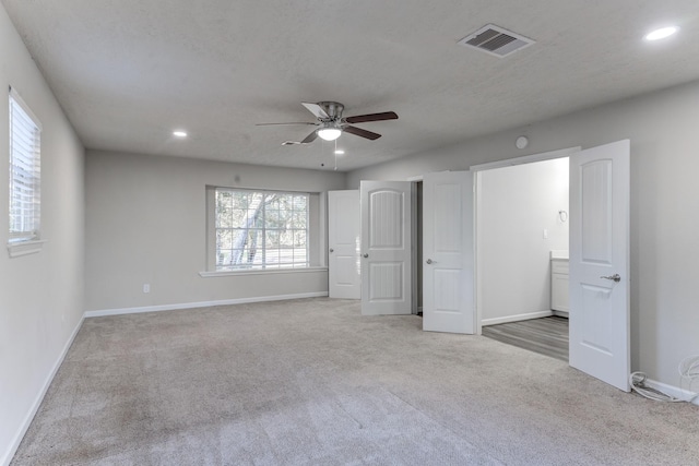 unfurnished bedroom featuring light carpet and ceiling fan