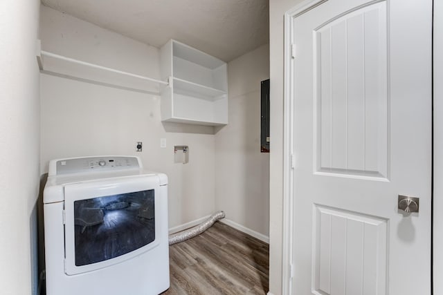 clothes washing area with washer / dryer and light hardwood / wood-style floors