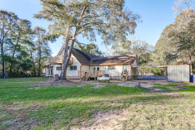 back of property with a lawn and a deck