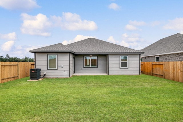 back of property featuring a lawn and central AC unit