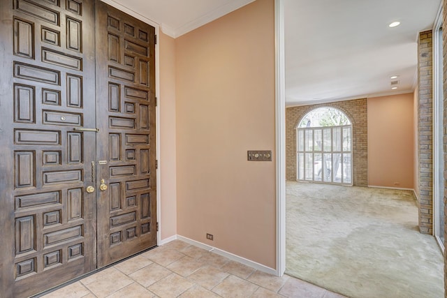 tiled entrance foyer with ornamental molding