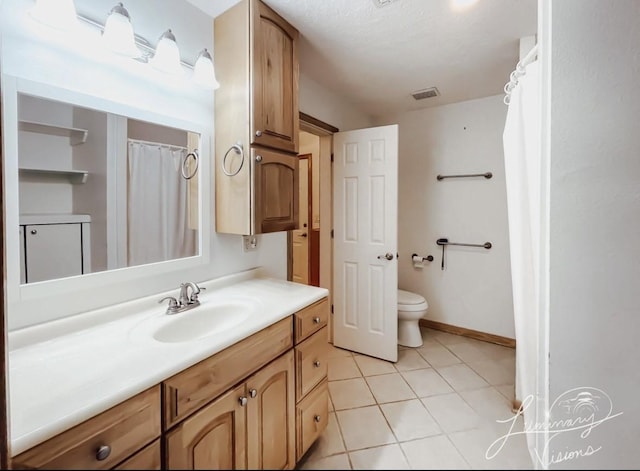 bathroom with tile patterned floors, vanity, and toilet