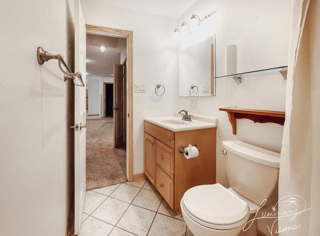 bathroom featuring toilet, tile patterned floors, and vanity