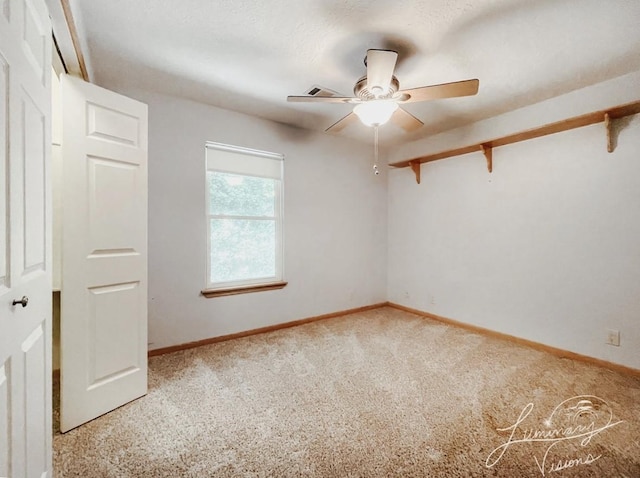 unfurnished room featuring ceiling fan and carpet flooring