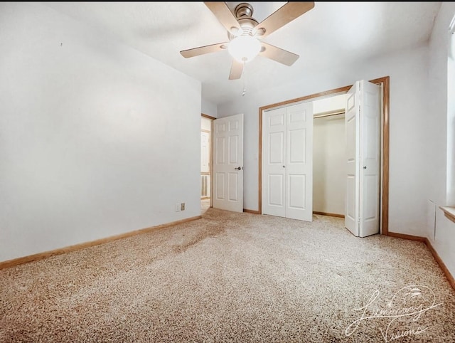 unfurnished bedroom with ceiling fan, carpet flooring, and a closet