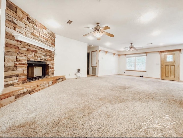 unfurnished living room with ceiling fan, a fireplace, and carpet flooring