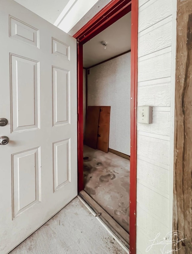 hall featuring concrete flooring