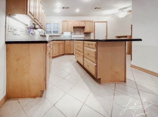 kitchen with ceiling fan, a center island, white electric range, sink, and light brown cabinets