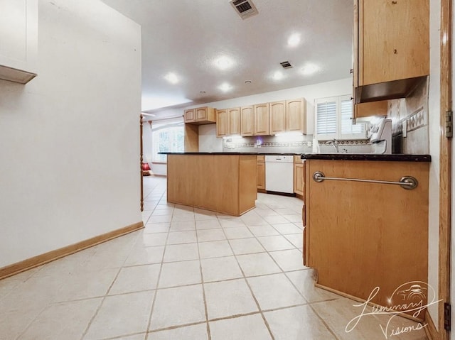 kitchen featuring light brown cabinets, light tile patterned flooring, dishwasher, and kitchen peninsula