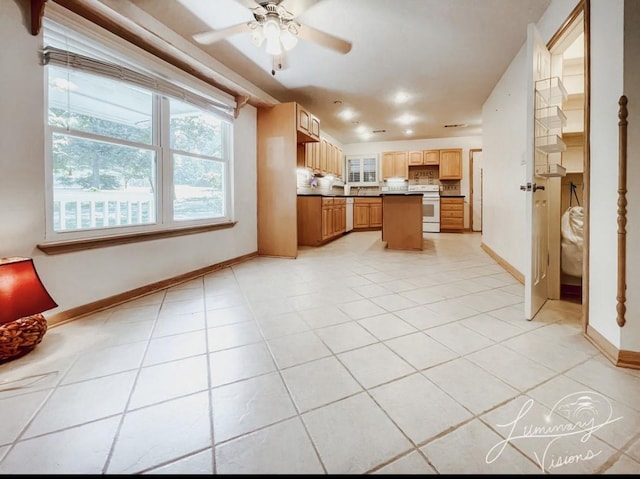 kitchen with white appliances, a center island, decorative backsplash, light tile patterned flooring, and ceiling fan