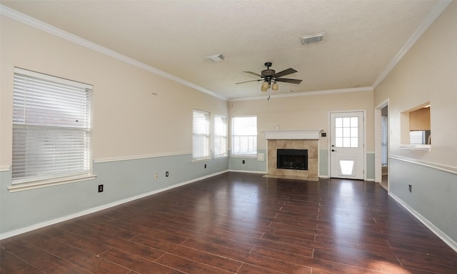 unfurnished living room featuring a fireplace, ornamental molding, and dark hardwood / wood-style floors