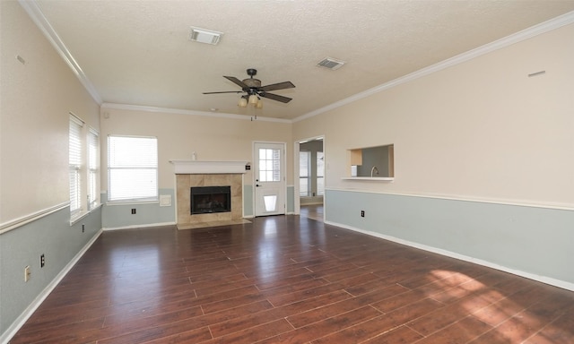 unfurnished living room with ceiling fan, plenty of natural light, and ornamental molding