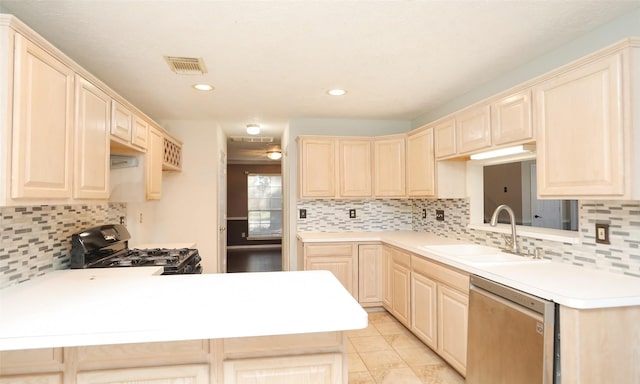 kitchen with tasteful backsplash, black gas range, stainless steel dishwasher, kitchen peninsula, and sink