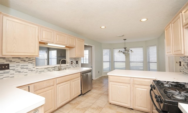 kitchen featuring sink, hanging light fixtures, kitchen peninsula, a notable chandelier, and stainless steel dishwasher