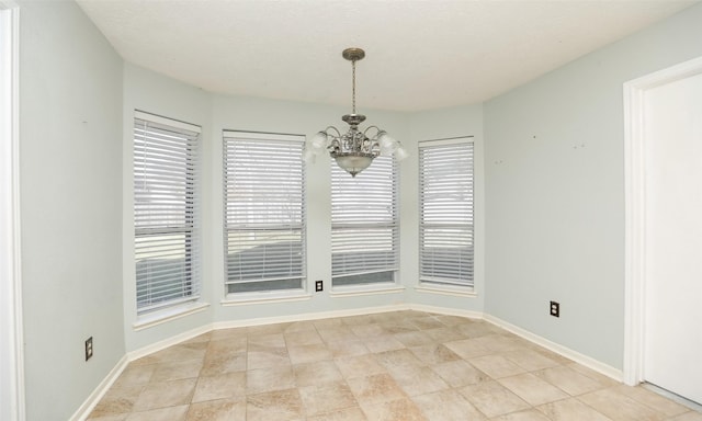 unfurnished dining area with light tile patterned floors and an inviting chandelier