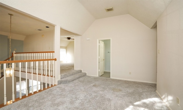 carpeted empty room with ceiling fan and lofted ceiling