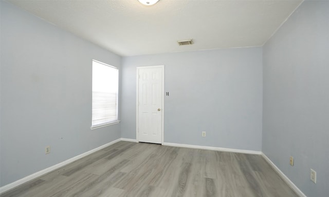 spare room with light hardwood / wood-style floors