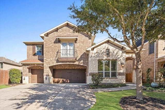 view of front of home featuring a garage and a balcony