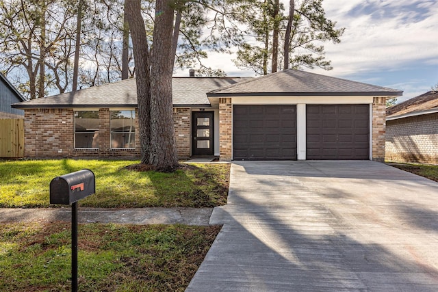 single story home featuring a garage and a front yard