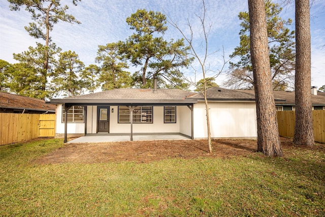 back of house featuring a patio area and a yard