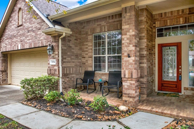 entrance to property featuring covered porch and a garage