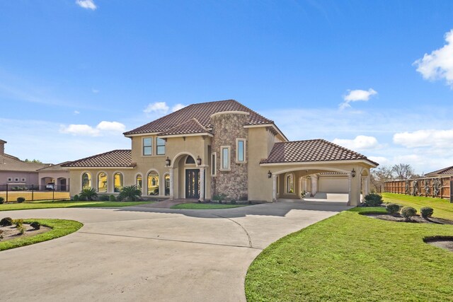 mediterranean / spanish-style house with a front lawn and a garage