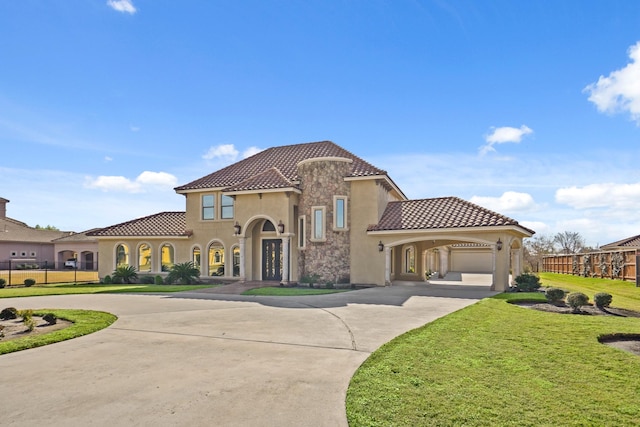 mediterranean / spanish-style house with a garage and a front lawn