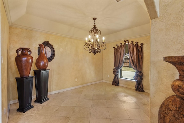 dining space featuring a tray ceiling and a chandelier