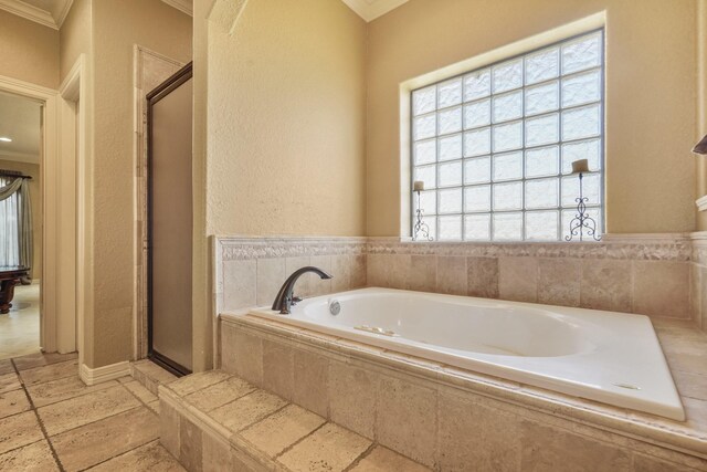 bathroom with ornamental molding, a wealth of natural light, and shower with separate bathtub