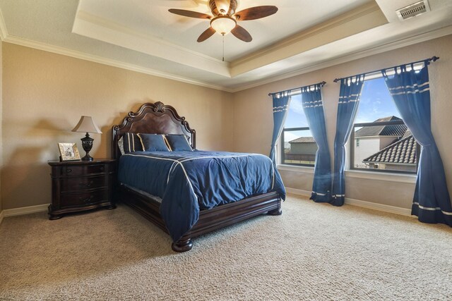 bedroom featuring crown molding, carpet, ceiling fan, and a raised ceiling