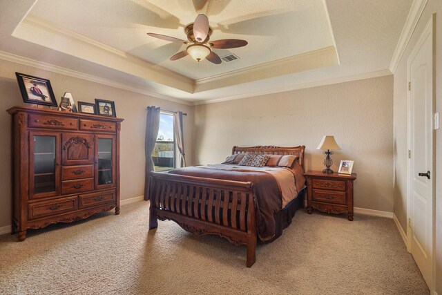 bedroom with ceiling fan, a raised ceiling, ornamental molding, and light carpet