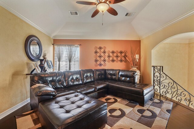 living room featuring ceiling fan, wood-type flooring, crown molding, and vaulted ceiling