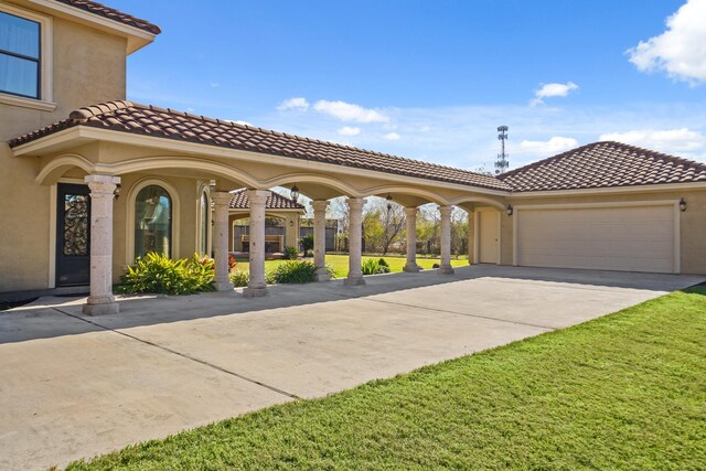 view of front of house with a garage and a front yard