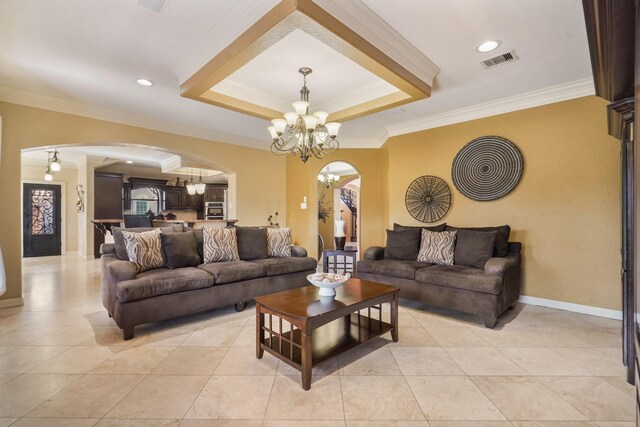 tiled living room with ornamental molding, a chandelier, and a raised ceiling