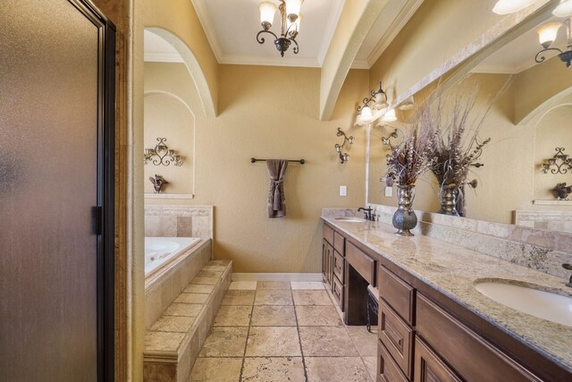 bathroom with vanity, crown molding, and tiled bath