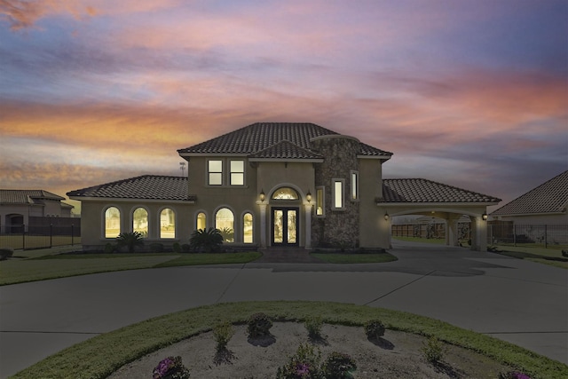 mediterranean / spanish home featuring a carport