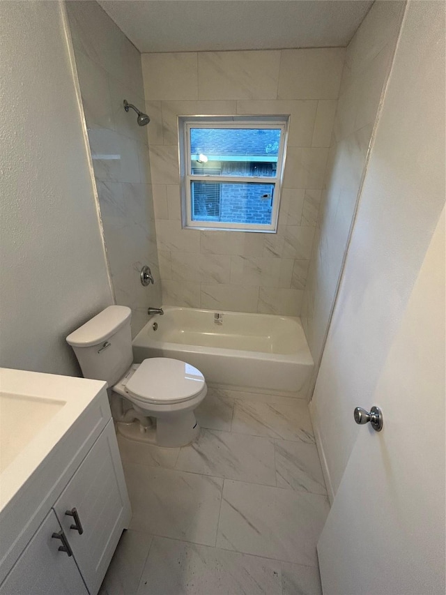 full bathroom with toilet, vanity, and tiled shower / bath