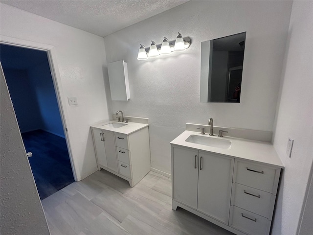 bathroom with a textured ceiling and vanity