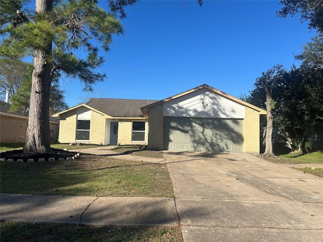 single story home featuring a garage and a front lawn