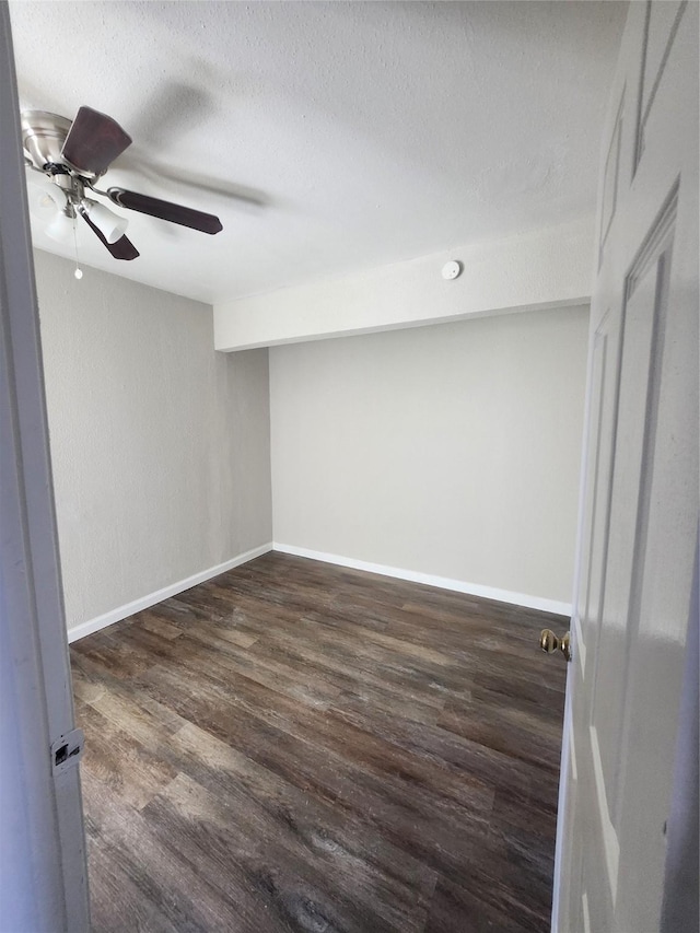 spare room featuring ceiling fan, a textured ceiling, and dark hardwood / wood-style flooring